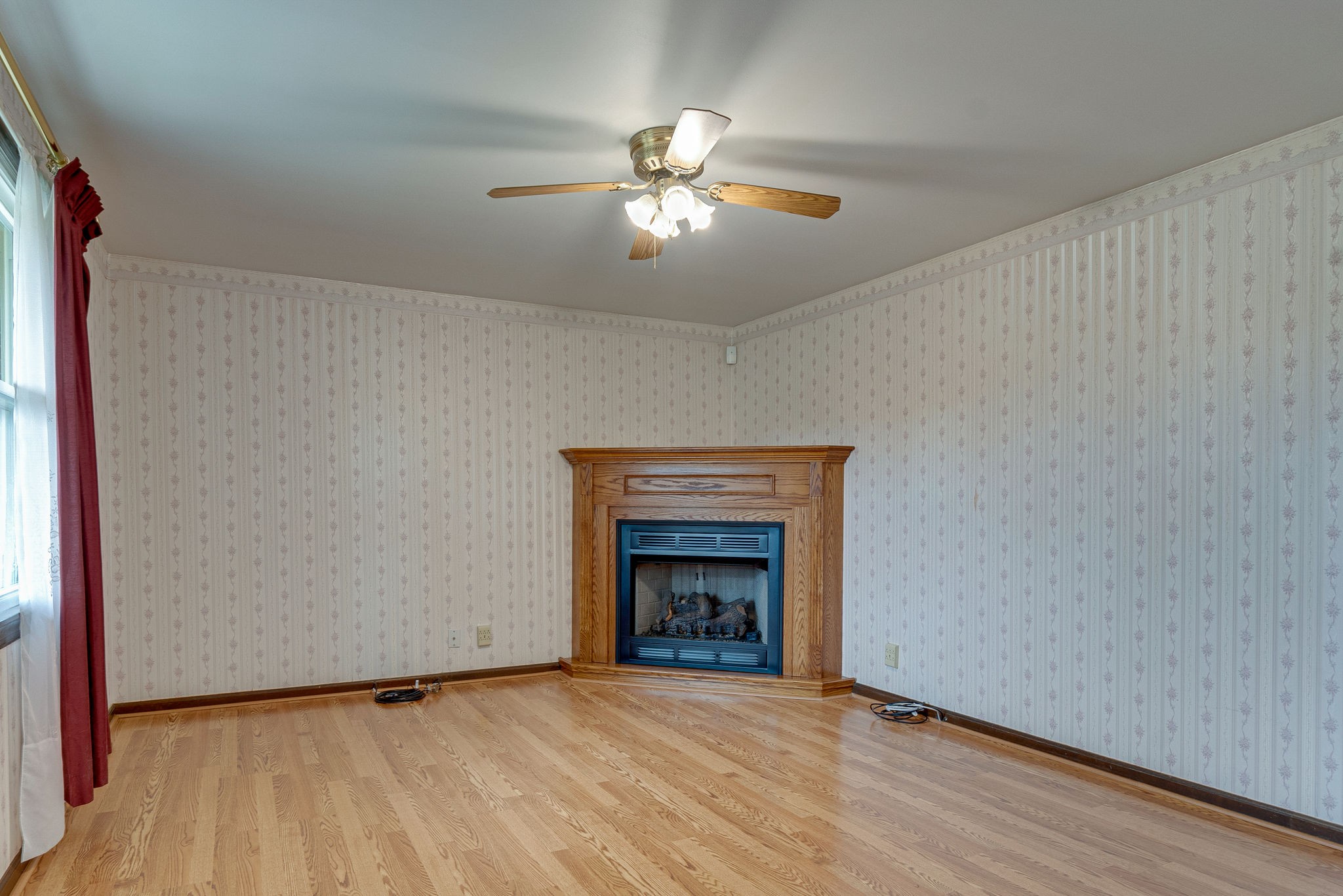 765 Lindsley Road Lebanon, TN 37090 - Photo 7 of 32 a view of an empty room with wooden floor fireplace and a window