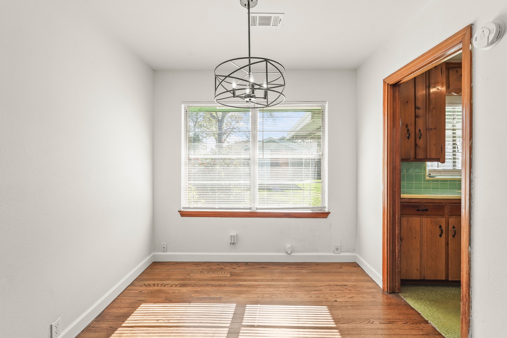 1207 Stonecrest Drive Houston, TX 77018 - Photo 13 of 34 a view of an empty room with wooden floor and a window
