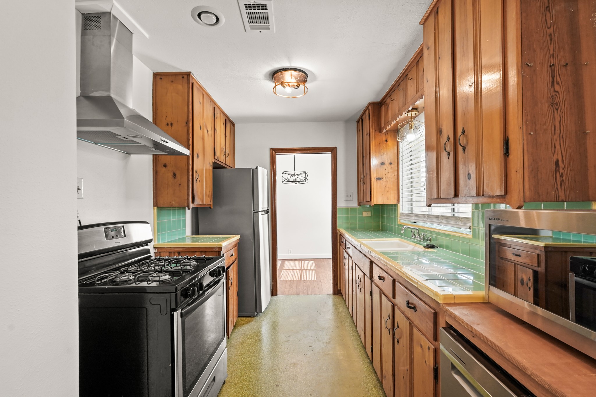 1207 Stonecrest Drive Houston, TX 77018 - Photo 17 of 34 a kitchen with stainless steel appliances granite countertop a stove and a refrigerator