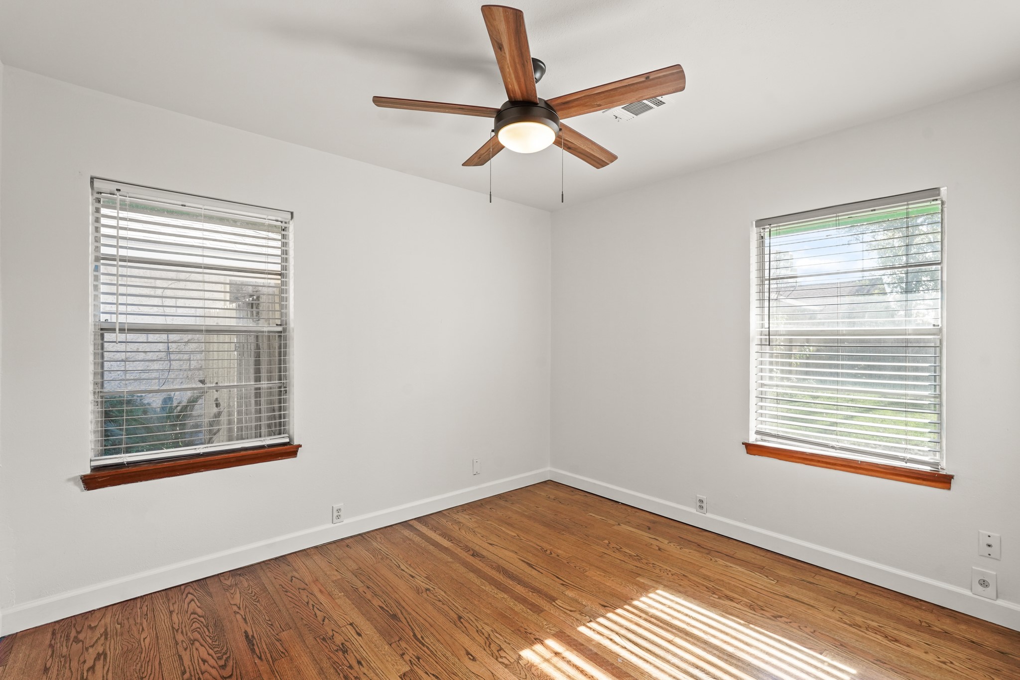 1207 Stonecrest Drive Houston, TX 77018 - Photo 24 of 34 a view of empty room with wooden floor and fan