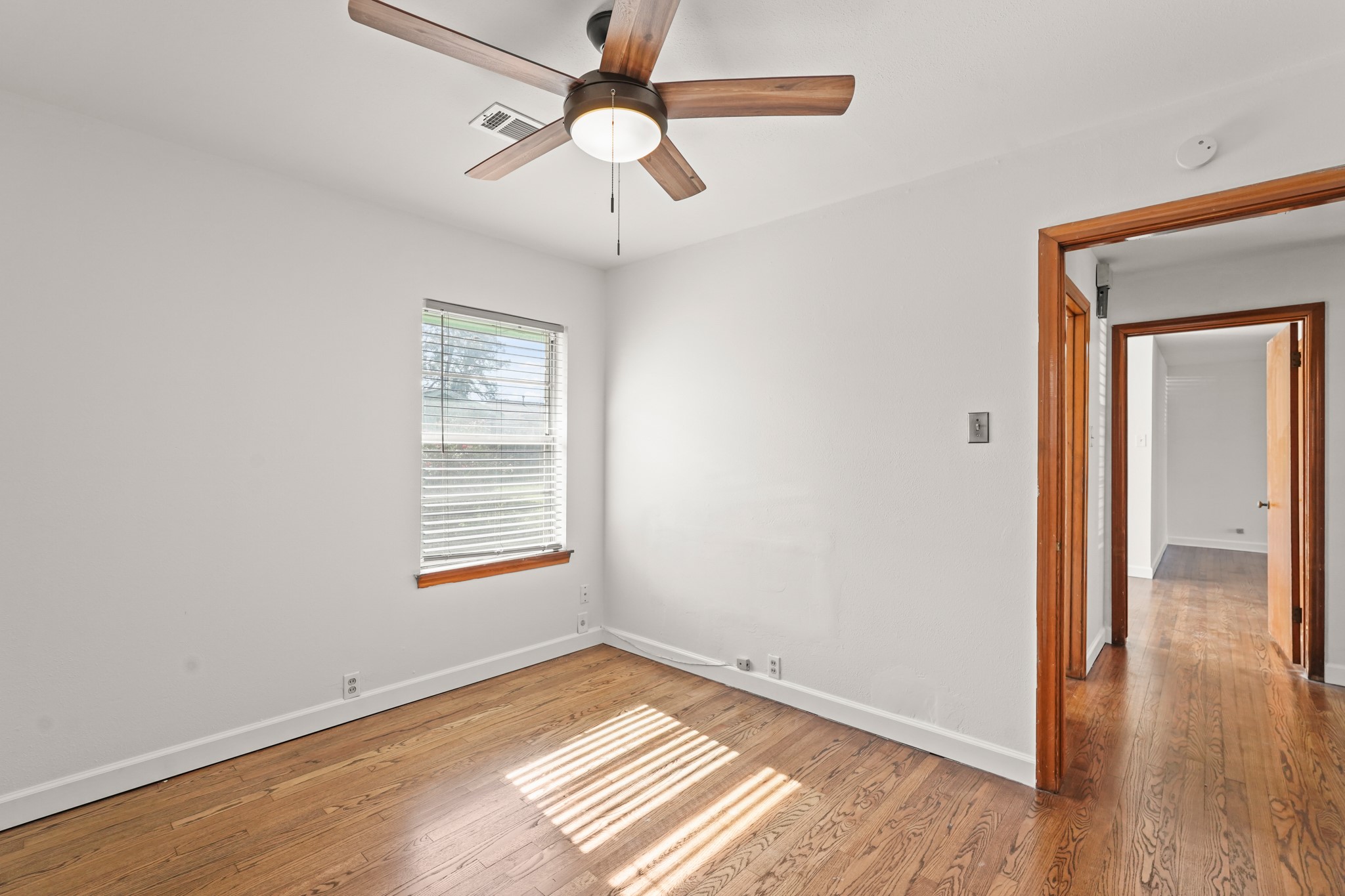 1207 Stonecrest Drive Houston, TX 77018 - Photo 25 of 34 a view of an empty room with wooden floor and a window