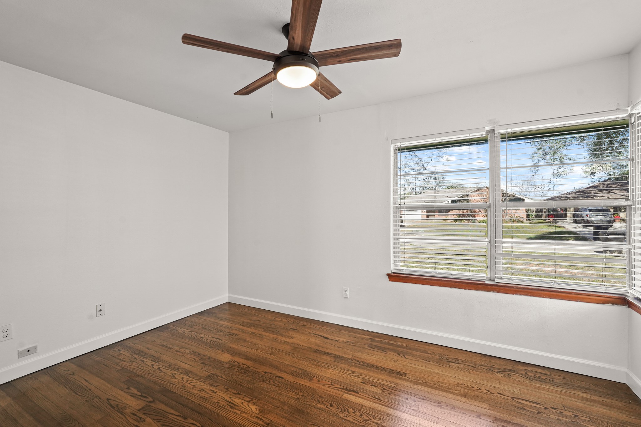 1207 Stonecrest Drive Houston, TX 77018 - Photo 31 of 34 an empty room with wooden floor and windows