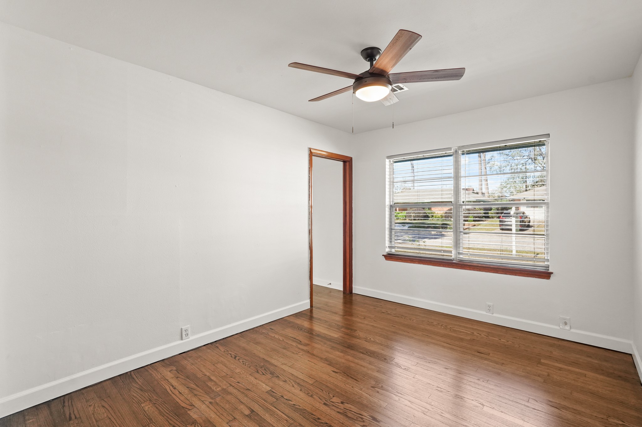 1207 Stonecrest Drive Houston, TX 77018 - Photo 32 of 34 a view of an empty room with wooden floor and a window