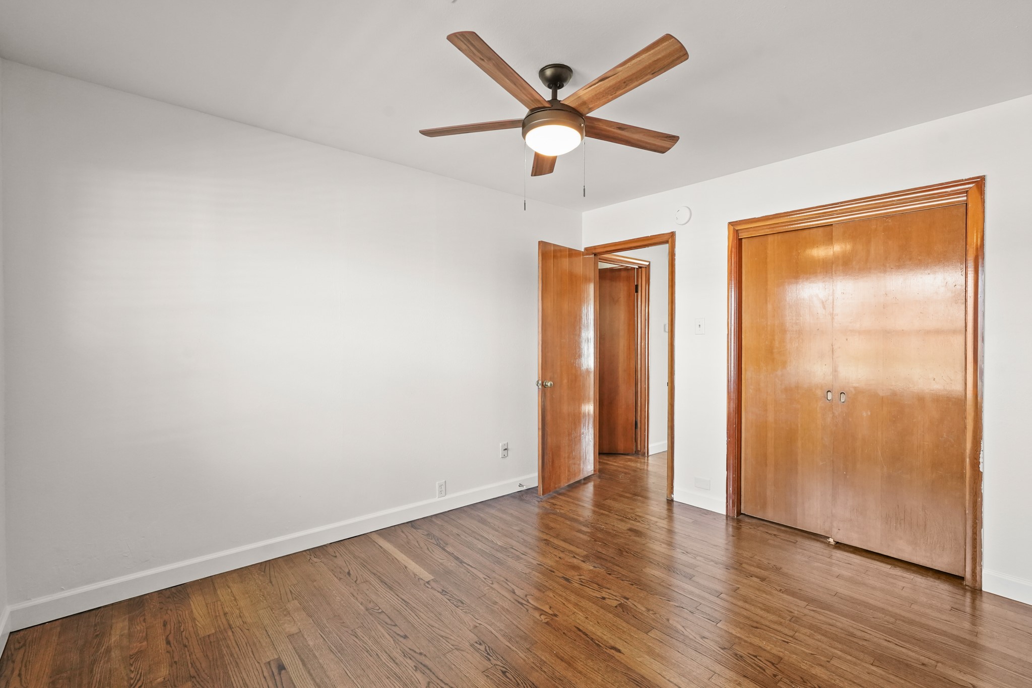 1207 Stonecrest Drive Houston, TX 77018 - Photo 34 of 34 an empty room to ceiling fan and wooden floor