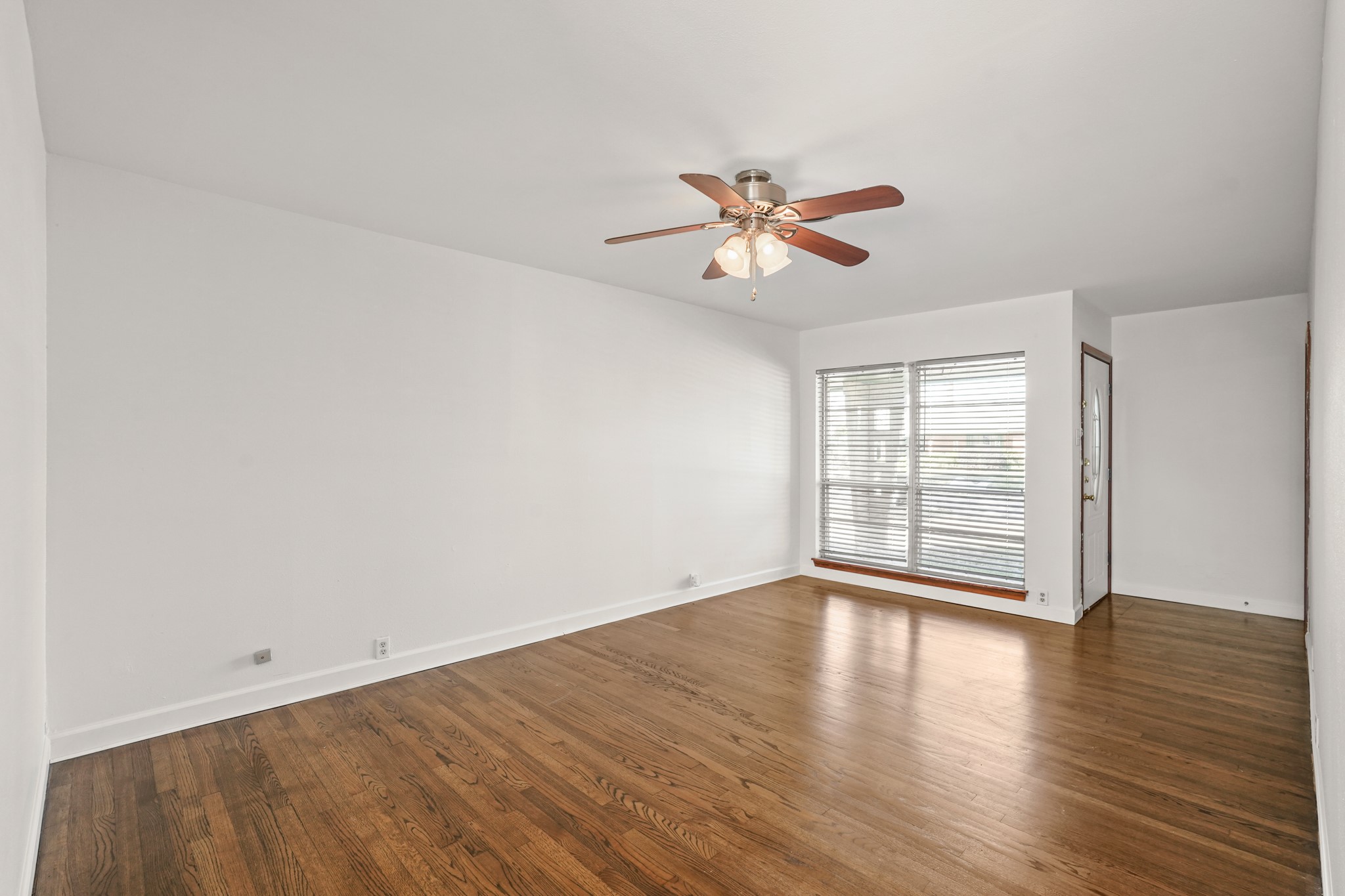 1207 Stonecrest Drive Houston, TX 77018 - Photo 9 of 34 wooden floor in an empty room with a window