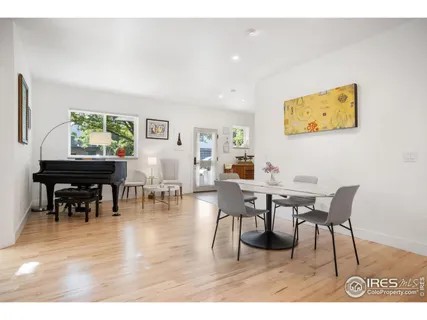 a dining room with furniture and wooden floor
