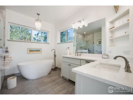 a bathroom with a sink a large mirror and a bathtub