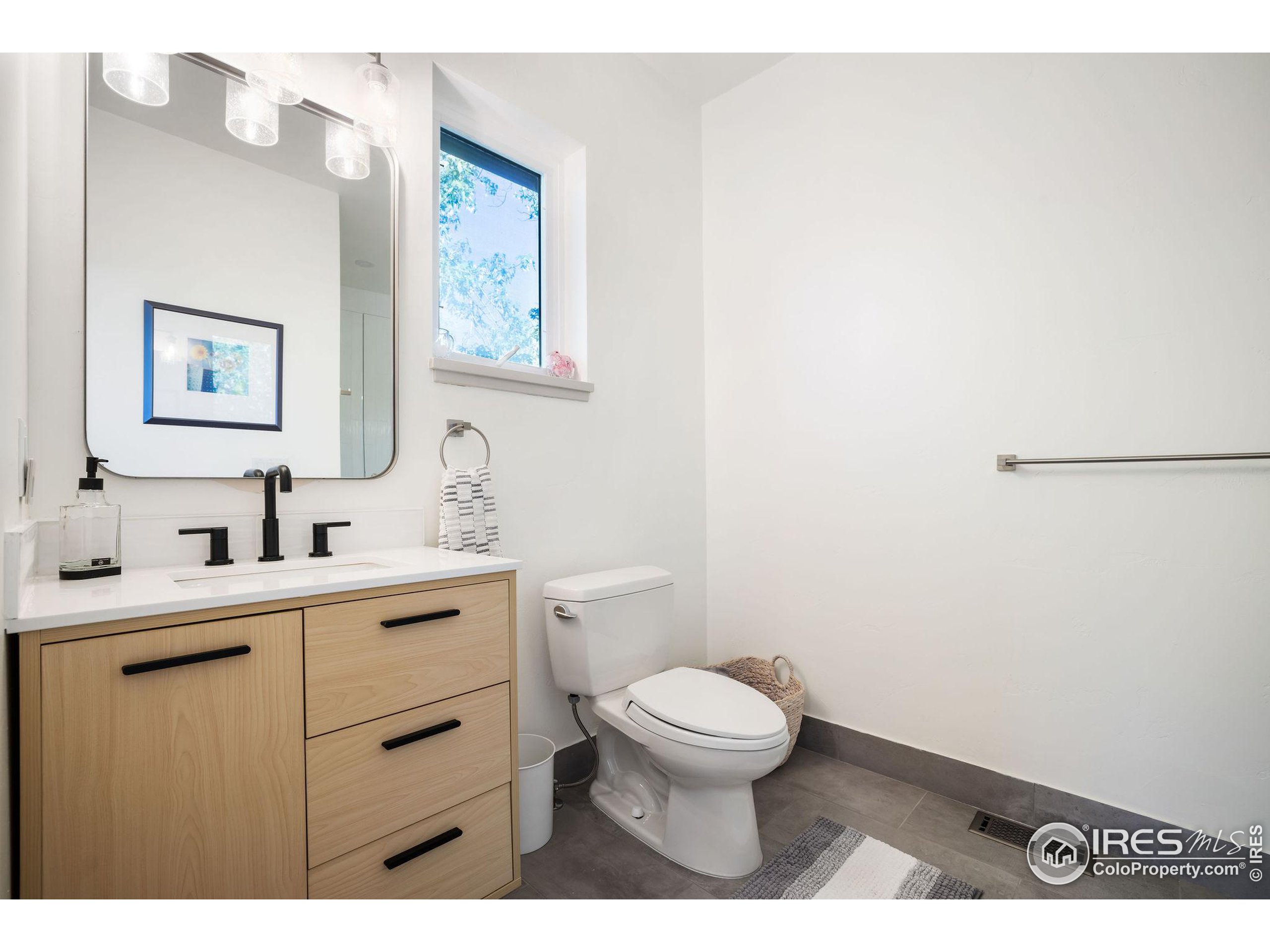 2870 18th Street Boulder, CO 80304 - Photo 28 of 39 a bathroom with a toilet a sink and mirror