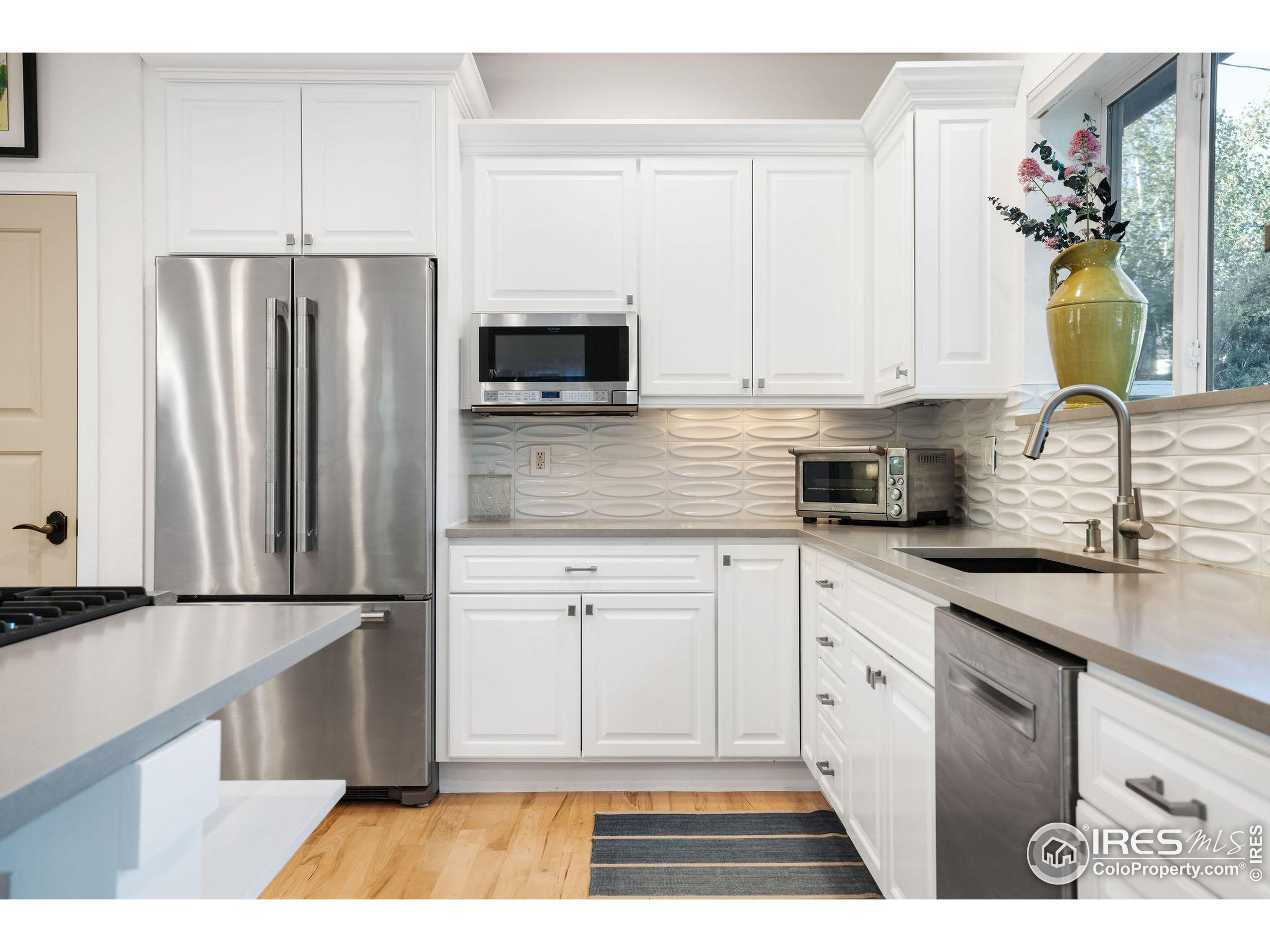 2870 18th Street Boulder, CO 80304 - Photo 10 of 39 a kitchen with stainless steel appliances granite countertop a refrigerator sink and microwave