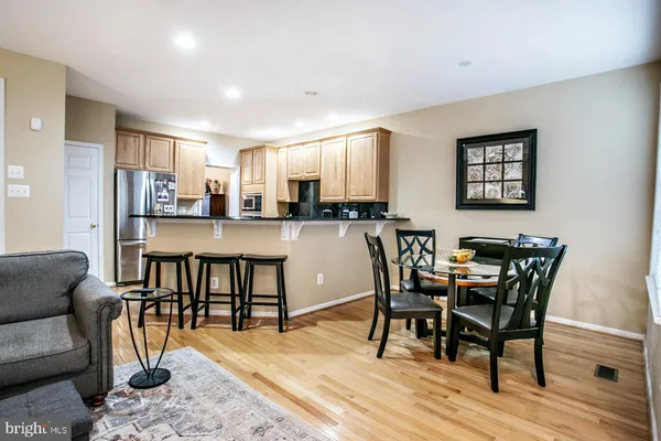 a dining room with furniture and wooden floor