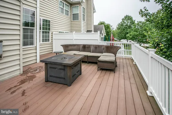 a balcony with furniture and wooden floor