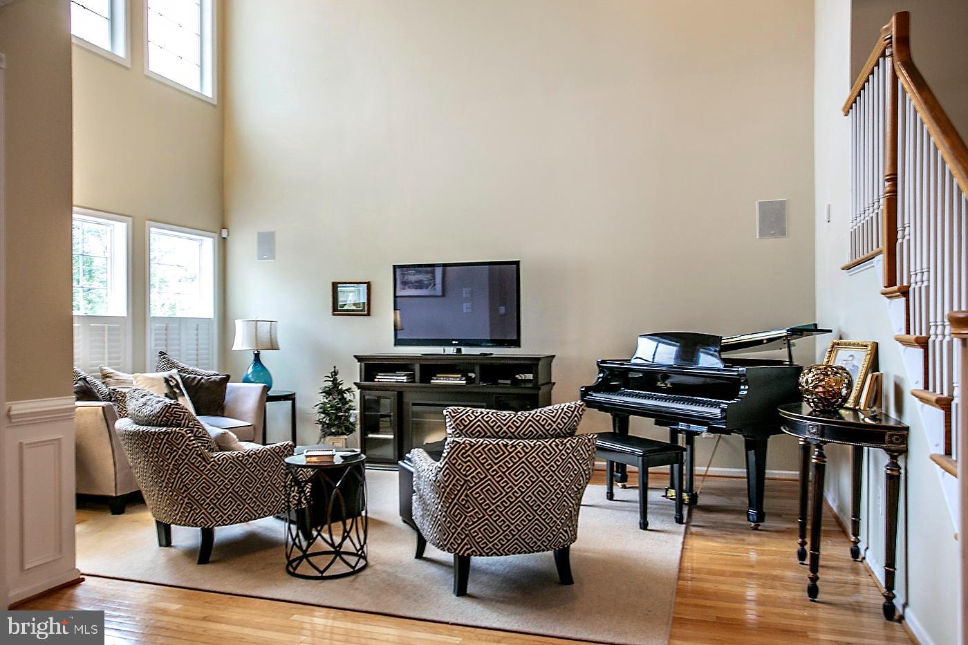 29 Eagle Road Phoenixville, PA 19460 - Photo 9 of 45 a living room with furniture a piano and a flat screen tv