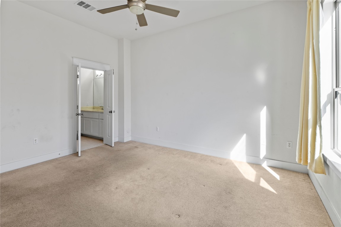 13001 Hymeadow Drive, Unit 31 Austin, TX 78729 - Photo 16 of 40 Unfurnished room with light carpet and ceiling fan