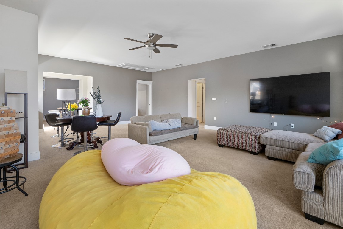 13001 Hymeadow Drive, Unit 31 Austin, TX 78729 - Photo 25 of 40 Living area with light colored carpet, attic access, and ceiling fan