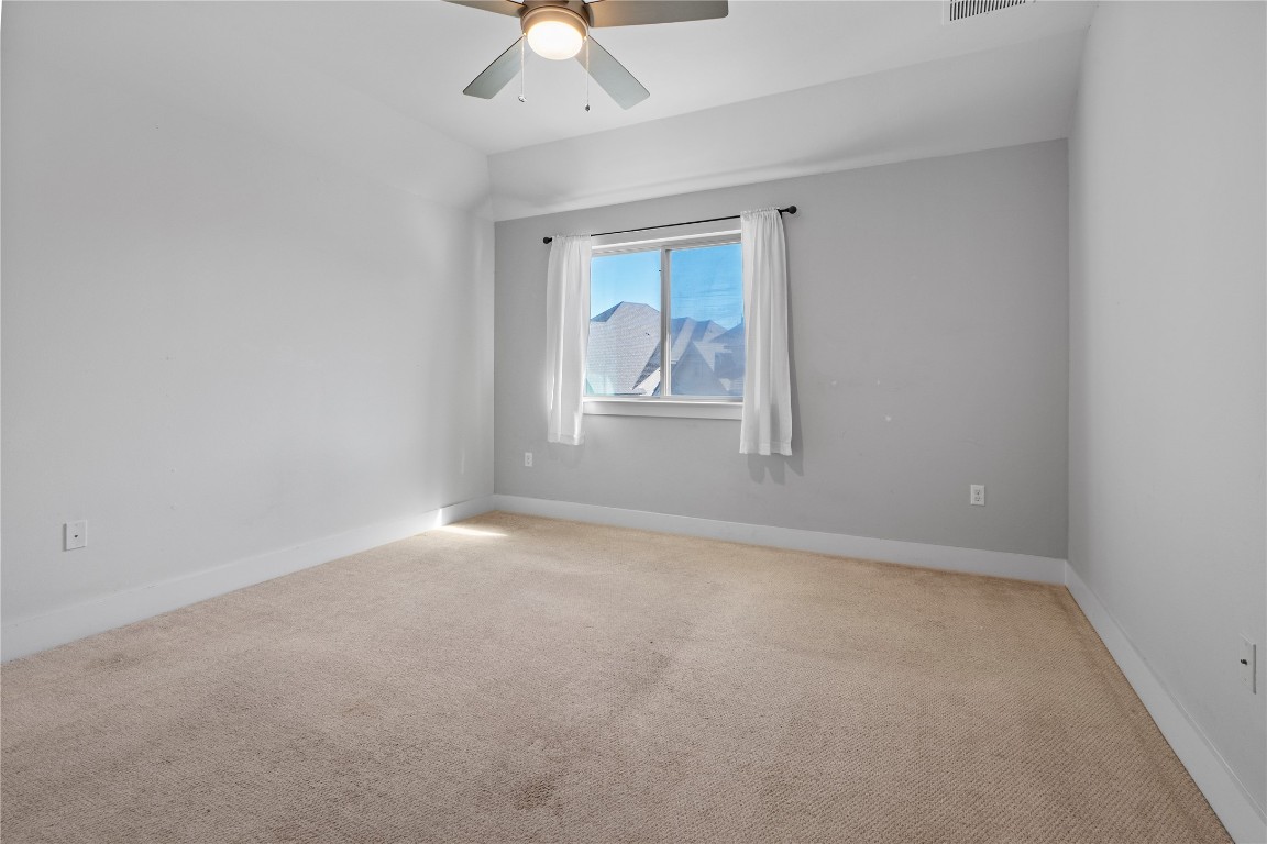 13001 Hymeadow Drive, Unit 31 Austin, TX 78729 - Photo 28 of 40 Spare room featuring light colored carpet and a ceiling fan