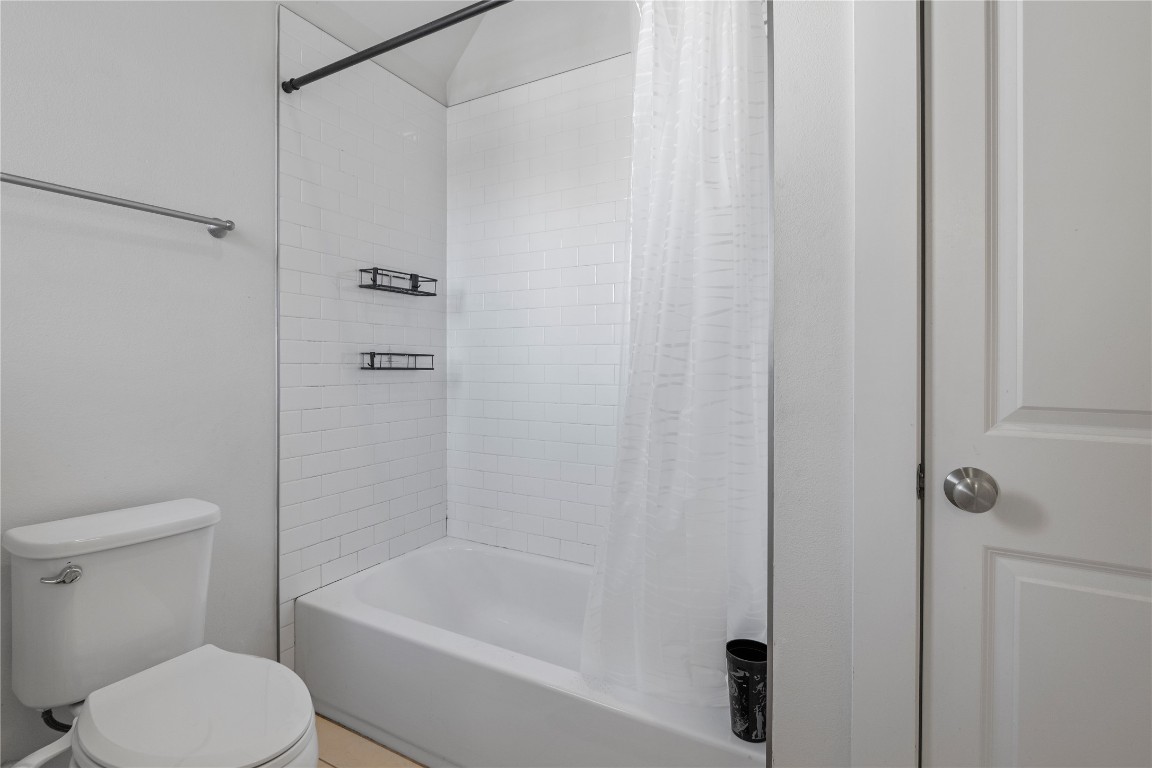 13001 Hymeadow Drive, Unit 31 Austin, TX 78729 - Photo 30 of 40 Bathroom with shower / bathtub combination with curtain and toilet