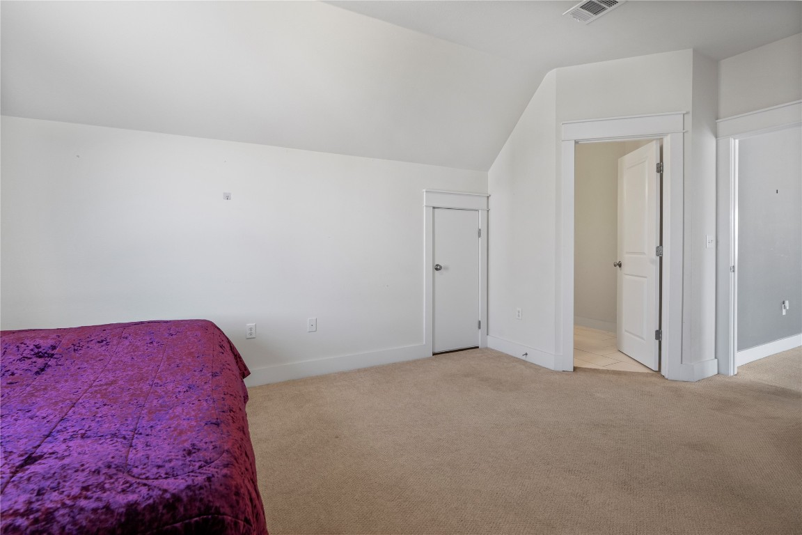 13001 Hymeadow Drive, Unit 31 Austin, TX 78729 - Photo 33 of 40 Bedroom featuring vaulted ceiling and light carpet