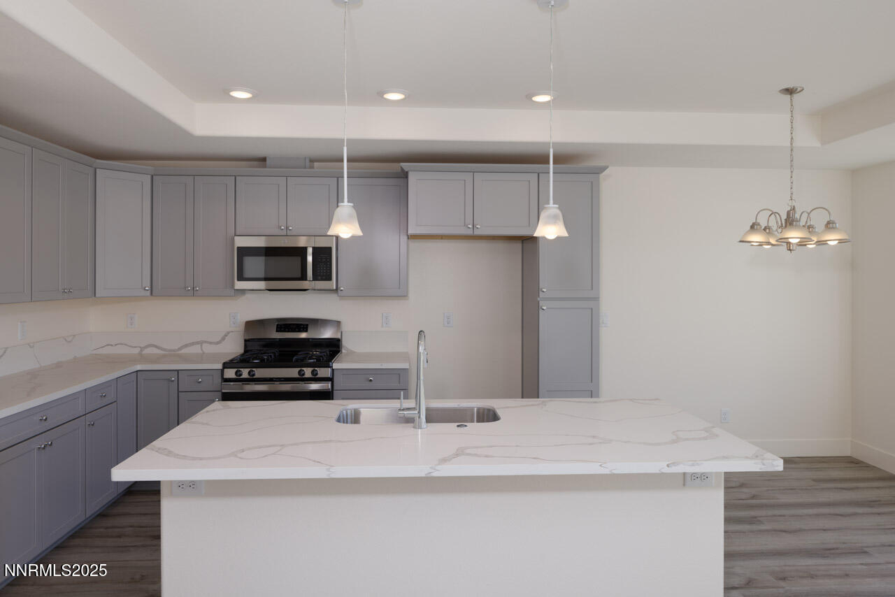 915 Saltbrush Road Dayton, NV 89403 - Photo 3 of 13 a kitchen with kitchen island a sink appliances and cabinets