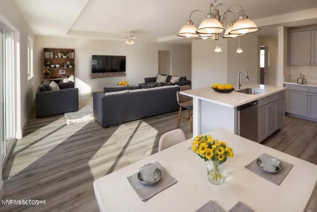a living room with furniture and a chandelier