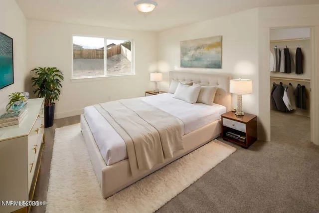 a spacious bedroom with a bed and a window