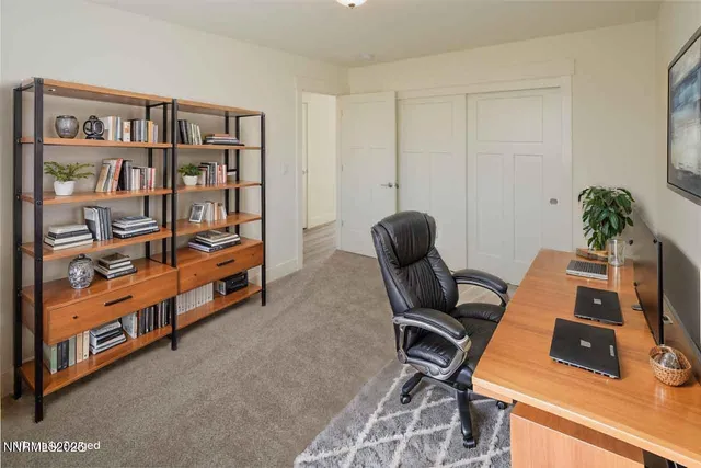 a bedroom with a bed and painting on the wall