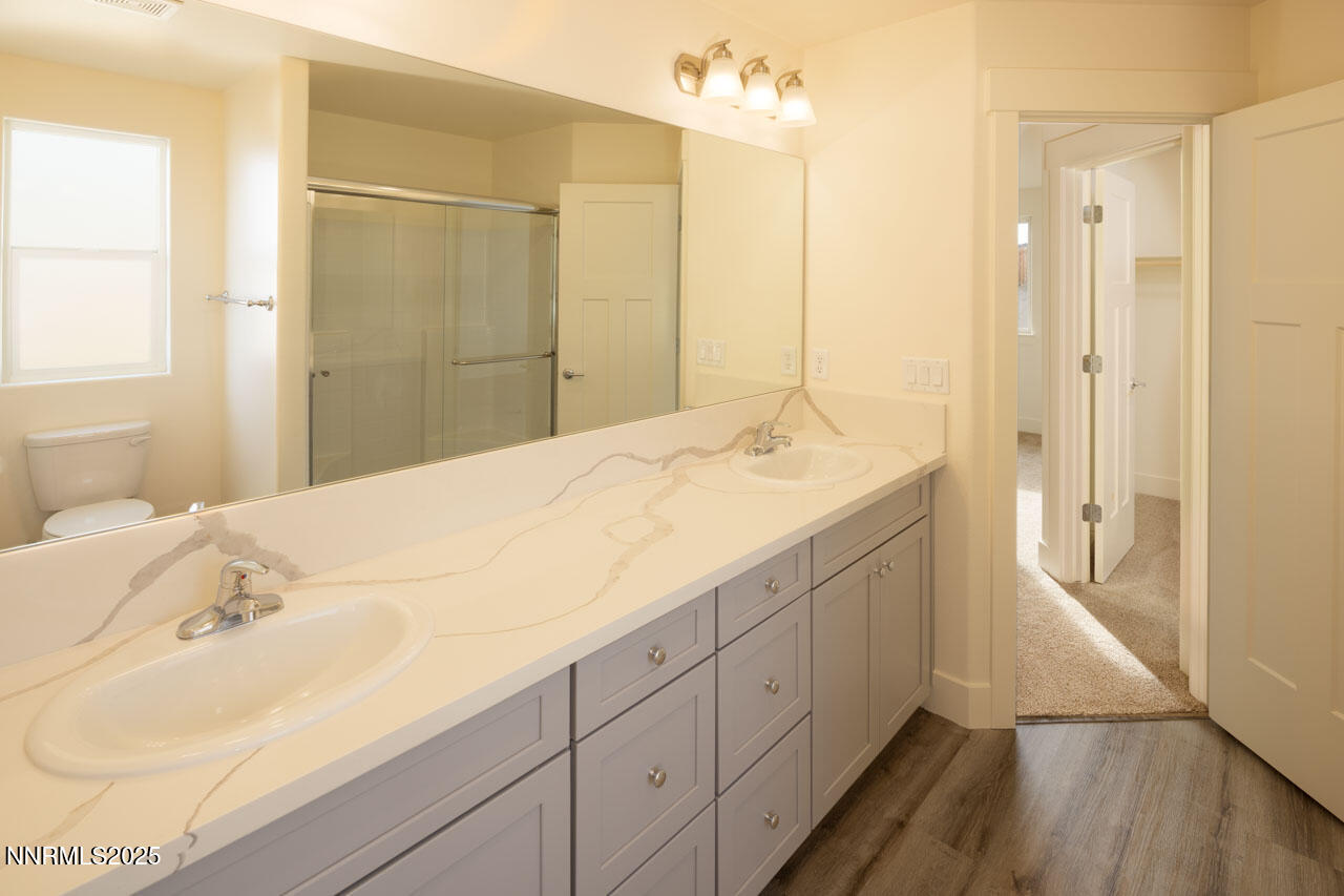 915 Saltbrush Road Dayton, NV 89403 - Photo 9 of 13 a spacious bathroom with a double vanity sink a mirror and shower