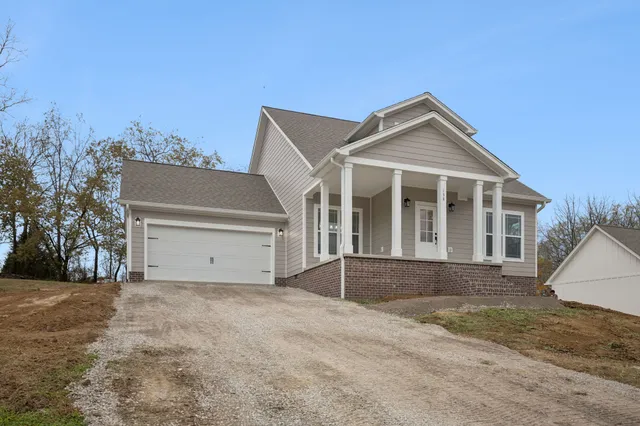 a big house with large trees and a big yard