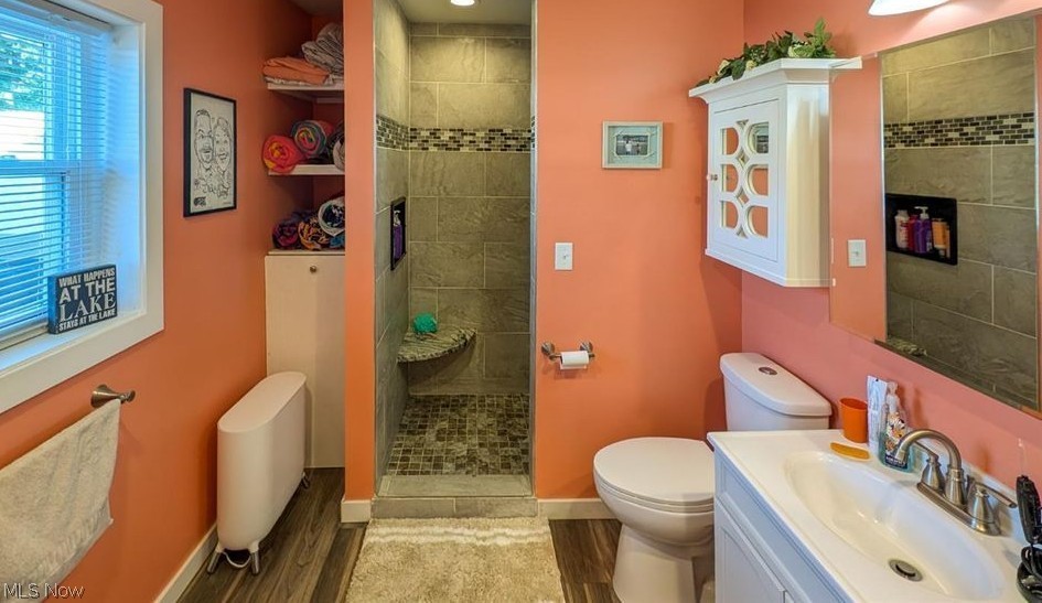 41 Poplar Street Huron, OH 44839 - Photo 14 of 37 Full bathroom featuring vanity, a tile shower, and wood-style flooring