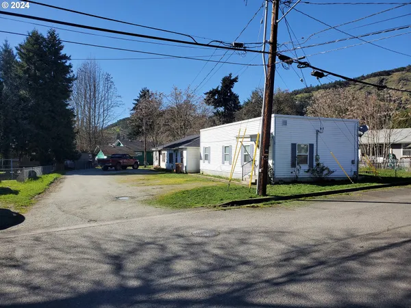 a view of a house with a yard and garage