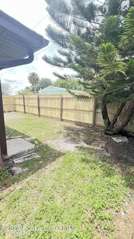 a view of a backyard of the house