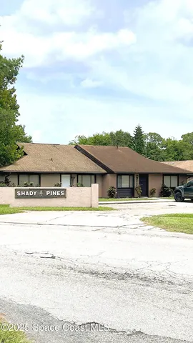 a view of a house with a yard and a mountain