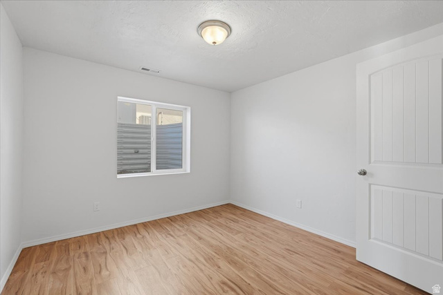 1218 Moonlight Drive Elk Ridge, UT 84651 - Photo 32 of 44 Empty room with light wood-type flooring and baseboards
