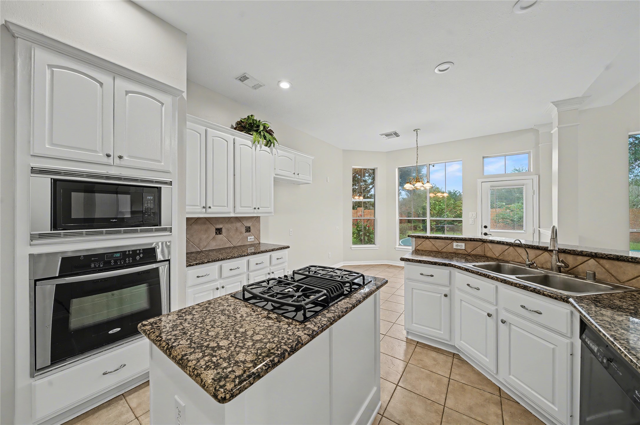 5403 Emerald Pointe Lane Sugar Land, TX 77479 - Photo 33 of 50 a kitchen with stainless steel appliances granite countertop a stove a sink and a microwave