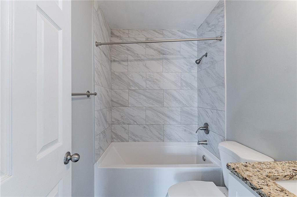1255 Glen Forest Way Decatur, GA 30032 - Photo 12 of 23 a bathroom with a bathtub and shower