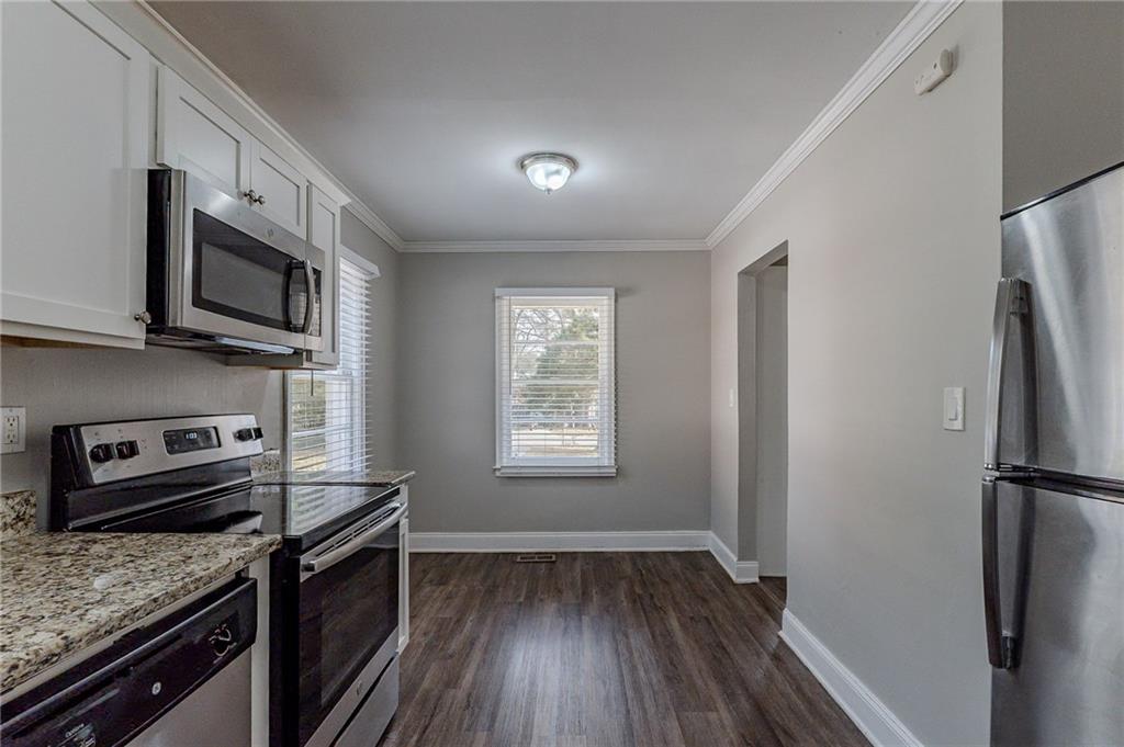1255 Glen Forest Way Decatur, GA 30032 - Photo 5 of 23 a kitchen with a refrigerator stove and microwave