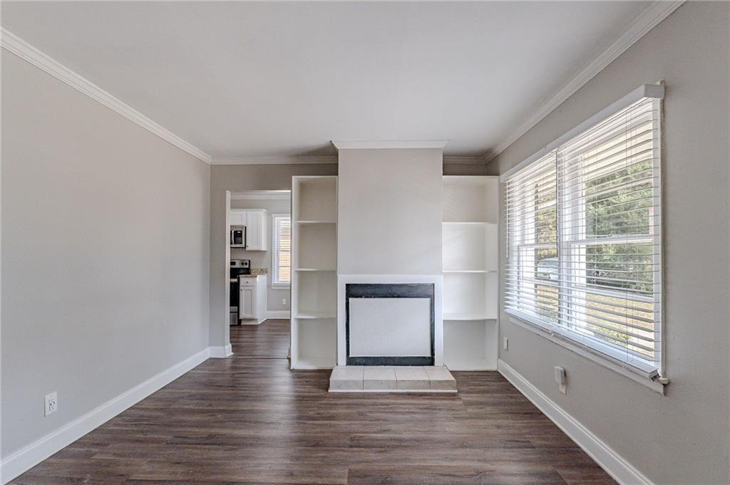 1255 Glen Forest Way Decatur, GA 30032 - Photo 7 of 23 a view of an empty room with a window and wooden floor