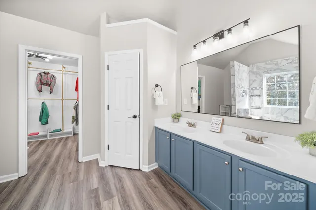 a spacious bathroom with a double vanity sink and mirror