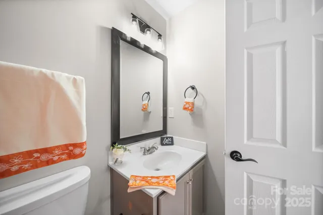 a bathroom with a granite countertop sink a toilet and shower