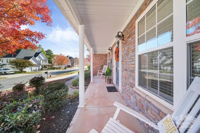 a view of a house with a yard and sitting area