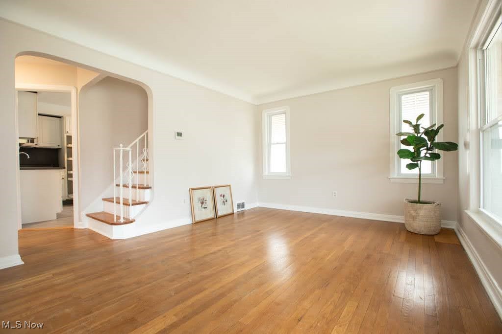 12822 Grannis Road Cleveland, OH 44125 - Photo 5 of 44 Unfurnished living room featuring sink, light hardwood / wood-style flooring, and ornamental molding