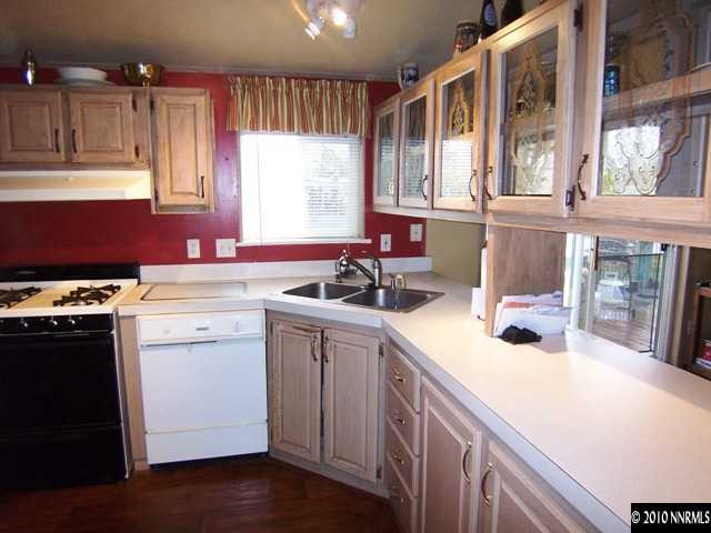 175 Aries Circle Reno, NV 89521 - Photo 2 of 13 a kitchen with a sink cabinets and window