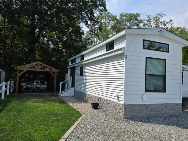 a view of a house with backyard and porch