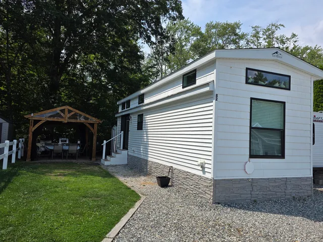a view of a house with backyard and porch