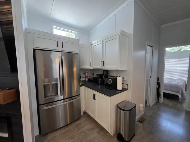 a kitchen with stainless steel appliances a refrigerator and a stove top oven