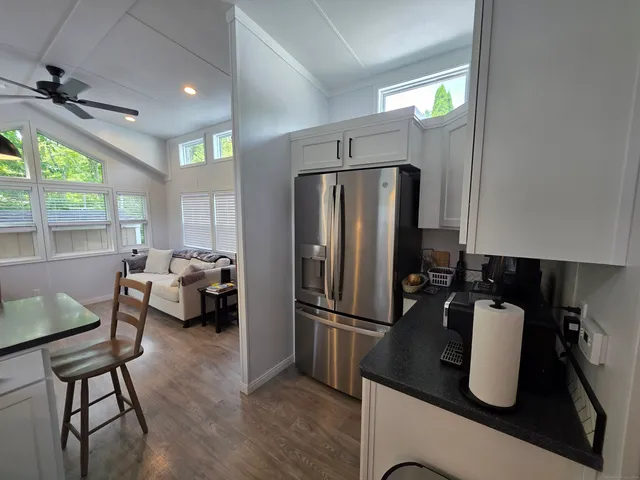 a kitchen with sink refrigerator and window