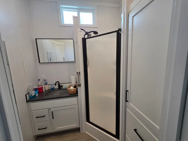 a bathroom with a shower and a mirror