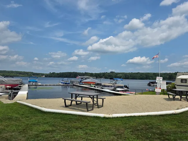 a swimming pool with outdoor seating and a garden