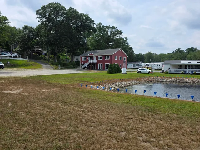 a view of a house with a big yard and large trees