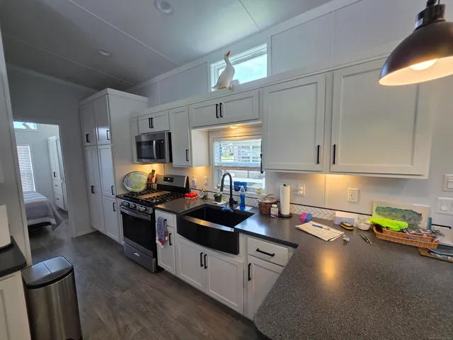 a kitchen with stove and cabinets