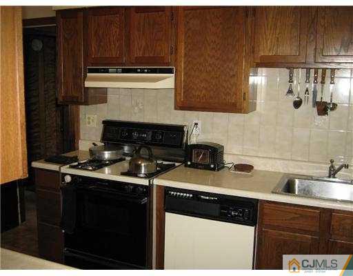 31 Purdue Road Old Bridge, NJ 08859 - Photo 3 of 6 a kitchen with stainless steel appliances granite countertop a sink stove and cabinets